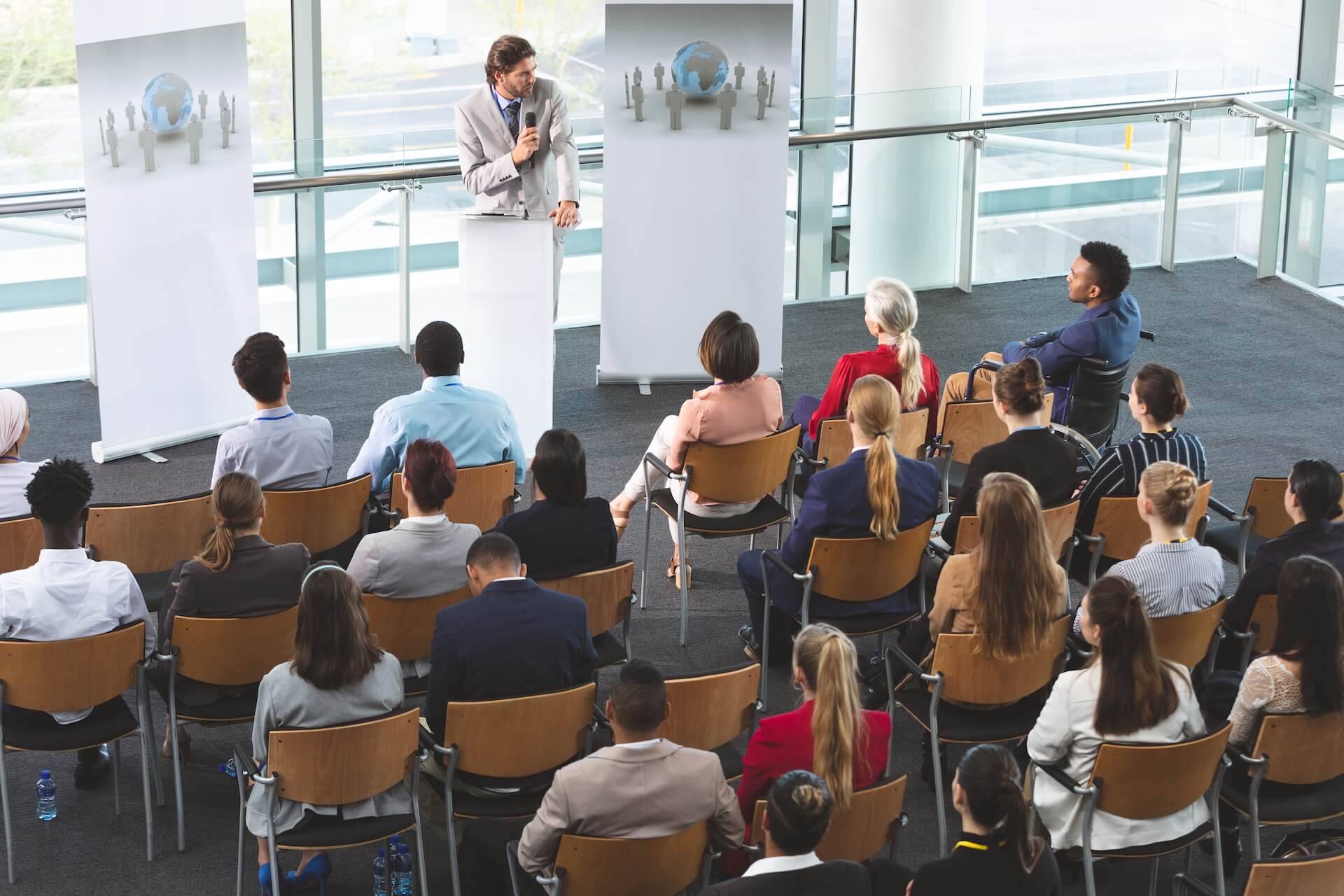 Businessman speaking into a microphone during a corporate keynote